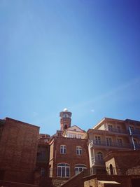 Low angle view of buildings against blue sky