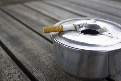 Burnt cigarette on ashtray over table