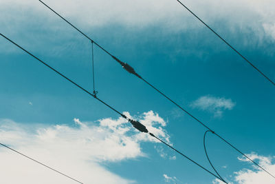 Low angle view of power lines against sky