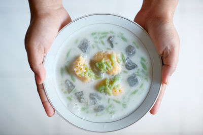 Midsection of person holding bowl of soup