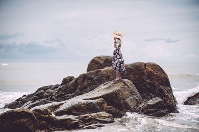 Full length of woman standing on rock