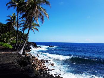 Scenic view of sea against blue sky