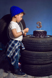 Baby boy eats his birthday cake in the form of a wheel in the studio