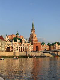 View of river by buildings against sky