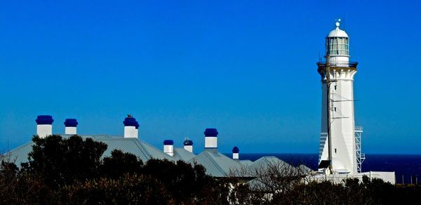 Low angle view of lighthouse against clear blue sky