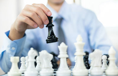 Midsection of woman holding chess