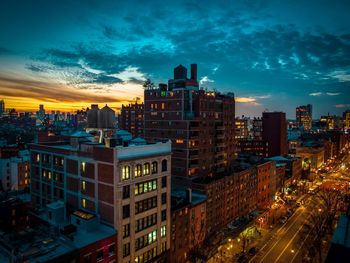 High angle view of illuminated buildings against sky at sunset