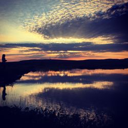 Reflection of clouds in lake at sunset