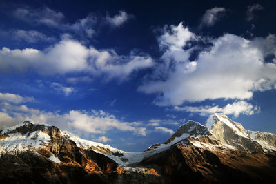 Scenic view of mountains against cloudy sky