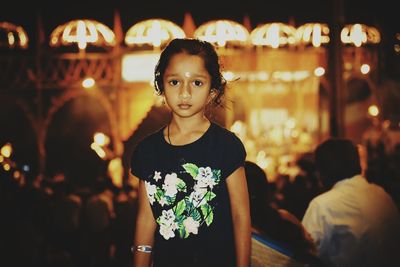 Portrait of girl standing at night