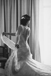 Rear view of woman with arms raised