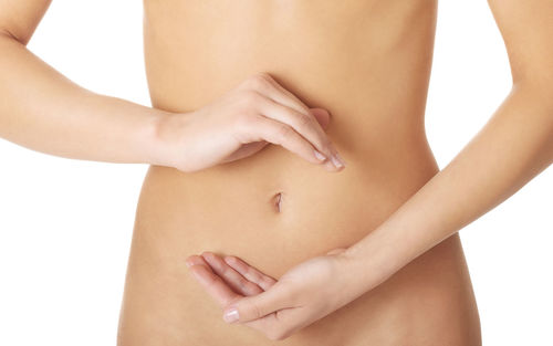 Close-up of woman touching hand over white background