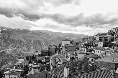 High angle view of houses in town against sky