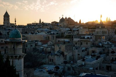 Townscape against sky at sunset