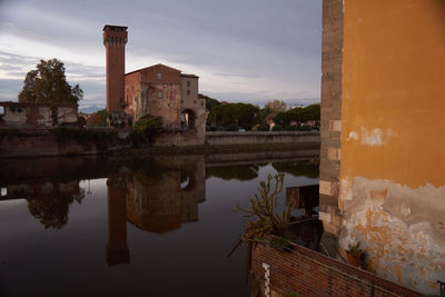 Reflection of buildings in lake at sunset