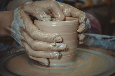 Creating ceramic products of white clay close-up. the sculptor in workshop makes clay jug closeup. 