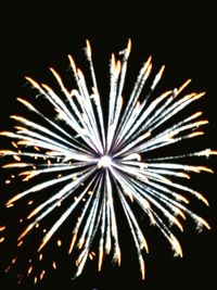 Low angle view of firework display at night