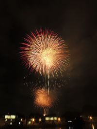 Low angle view of firework display at night