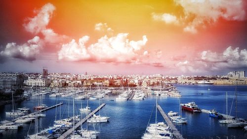 High angle view of city by sea against sky