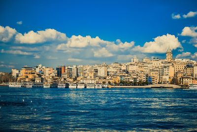Scenic view of sea and buildings against sky