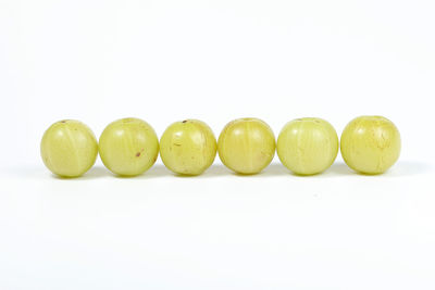 Close-up of fruits over white background