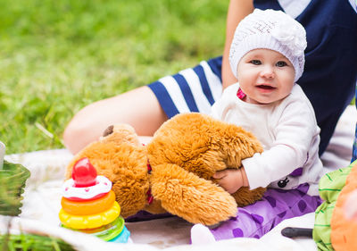 Cute baby girl playing with toy