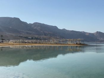 Scenic view of lake against clear blue sky