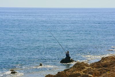 Scenic view of sea against blue sky