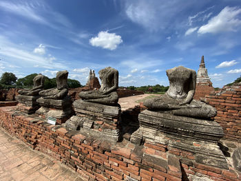 Ruins of temple against cloudy sky