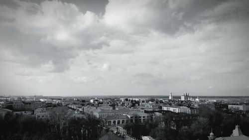 View of cityscape against cloudy sky