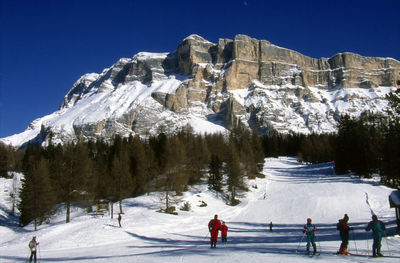 Tourists on snow covered mountain