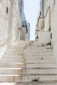 A beautiful view of the whitewashed street staircase in the city of ostuni.