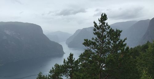 Scenic view of mountain range against sky during foggy weather