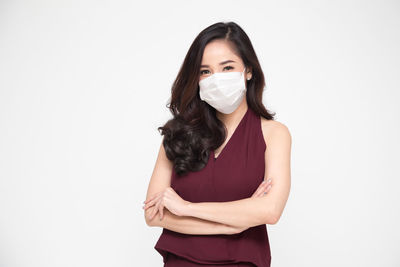 Portrait of beautiful young woman against white background