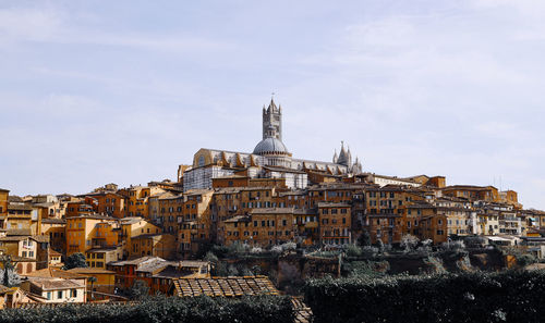 Buildings in city against sky