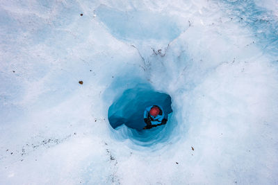 High angle view of man amidst glacier