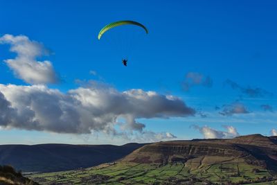People paragliding against sky