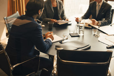 High angle view of financial advisors discussing in meeting at board room