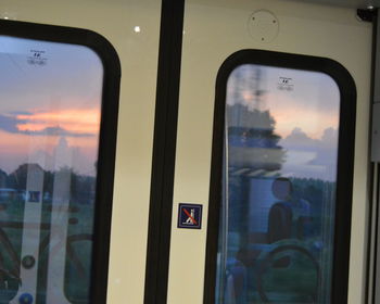 View of sunset seen through train window