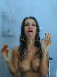 Portrait of young woman standing in bathroom