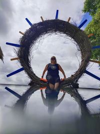 Portrait of woman standing against sky