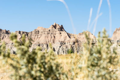 Low angle view of rocks against clear sky