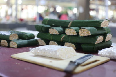 Close-up of food wrapped in banana leaves on wooden table