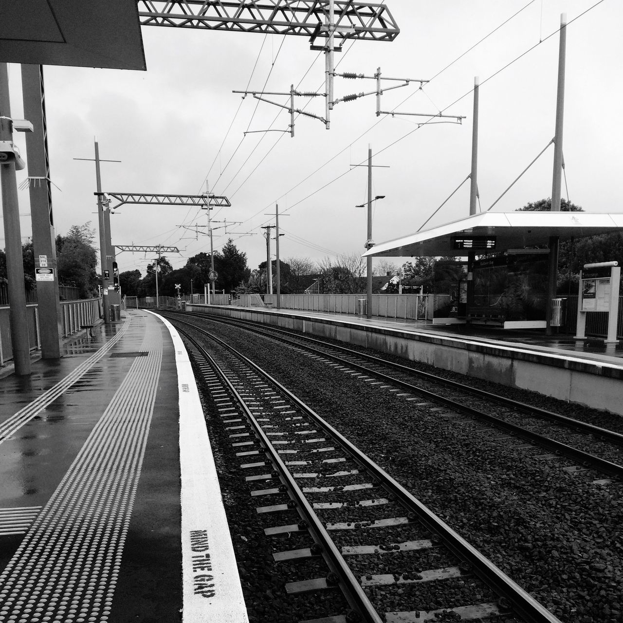 railroad track, rail transportation, transportation, public transportation, railroad station platform, railroad station, railway track, train - vehicle, diminishing perspective, built structure, travel, power line, architecture, sky, the way forward, public transport, railway station, train, vanishing point, building exterior