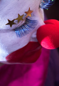 Close-up of woman with face paint and clown