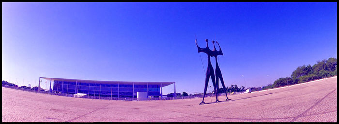 Panoramic view of built structure against clear blue sky