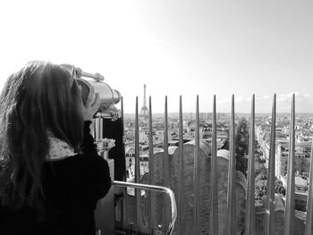 Portrait of woman looking at camera against sky