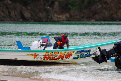 People on boat at beach