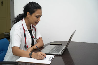 Full length of woman using mobile phone