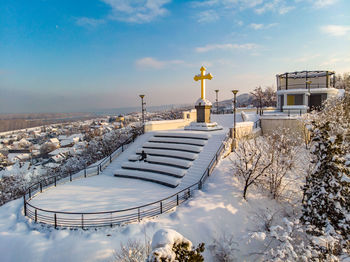 Snow covered buildings against sky during winter